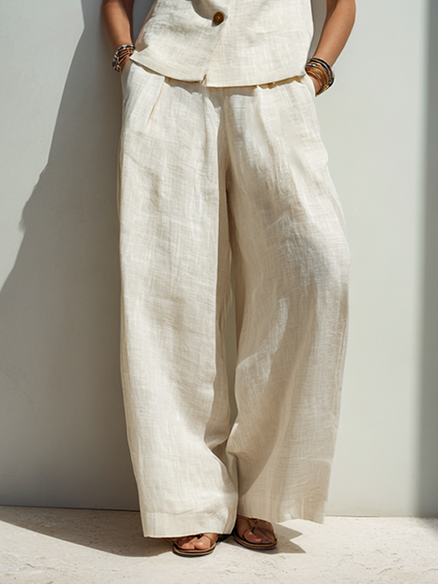 Completo minimalista da donna in misto cotone e lino con gilet abbottonato e pantaloni a gamba larga.
